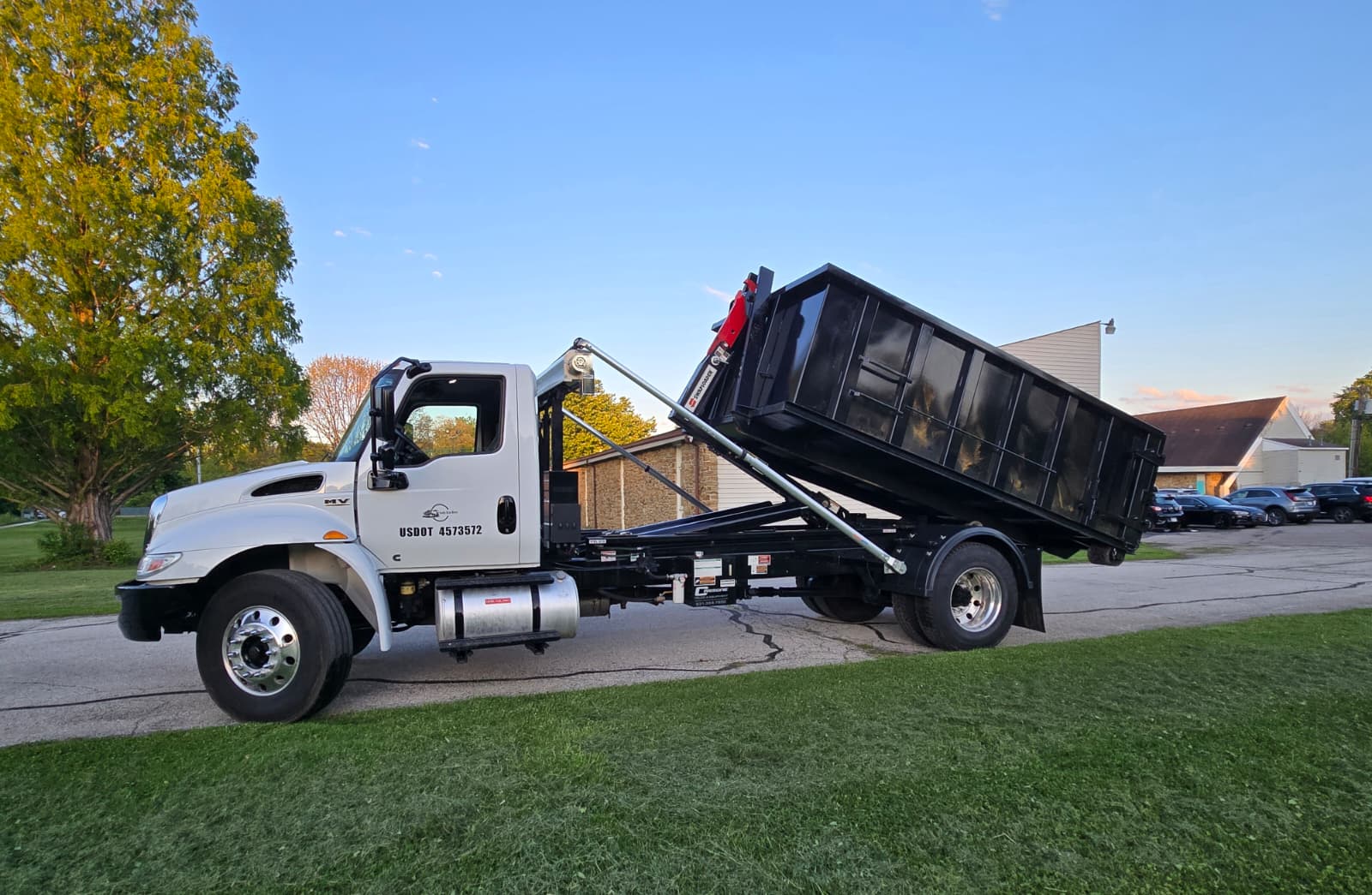 Dumpster delivery in progress